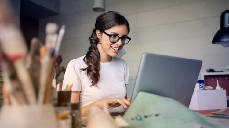 woman working on computer making extra money