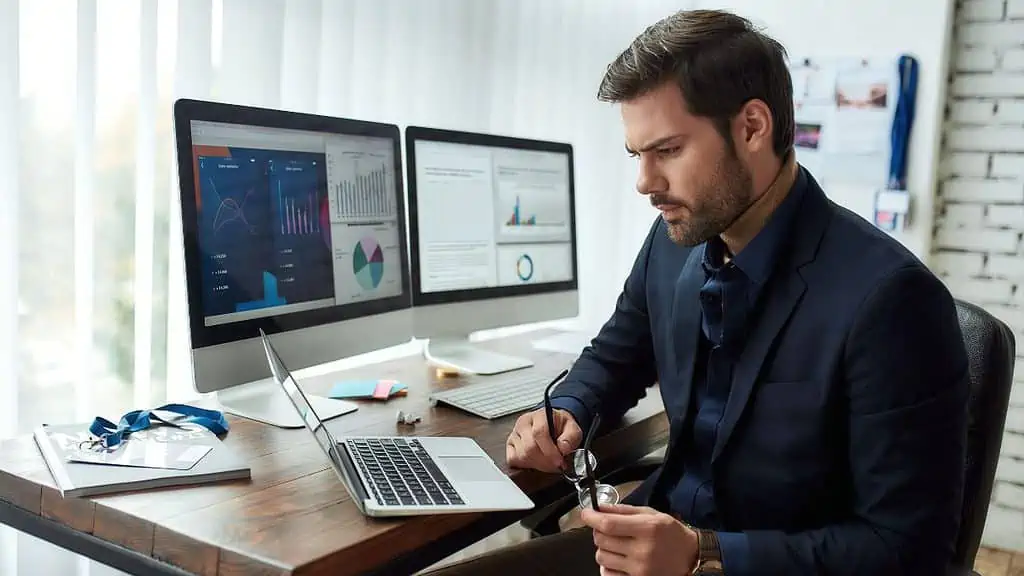 financial analyst man working ss msn - 10 Jobs That Will Be "Long Gone" in 10 Years - Thanks to Our AI Overlords