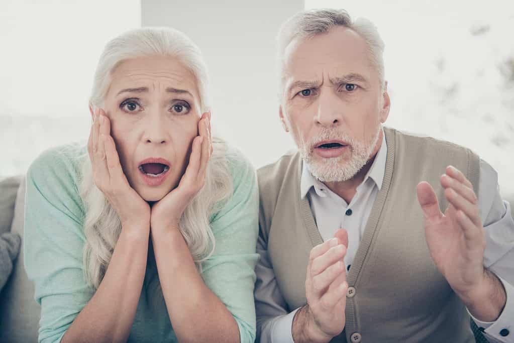 older man and woman couple scared