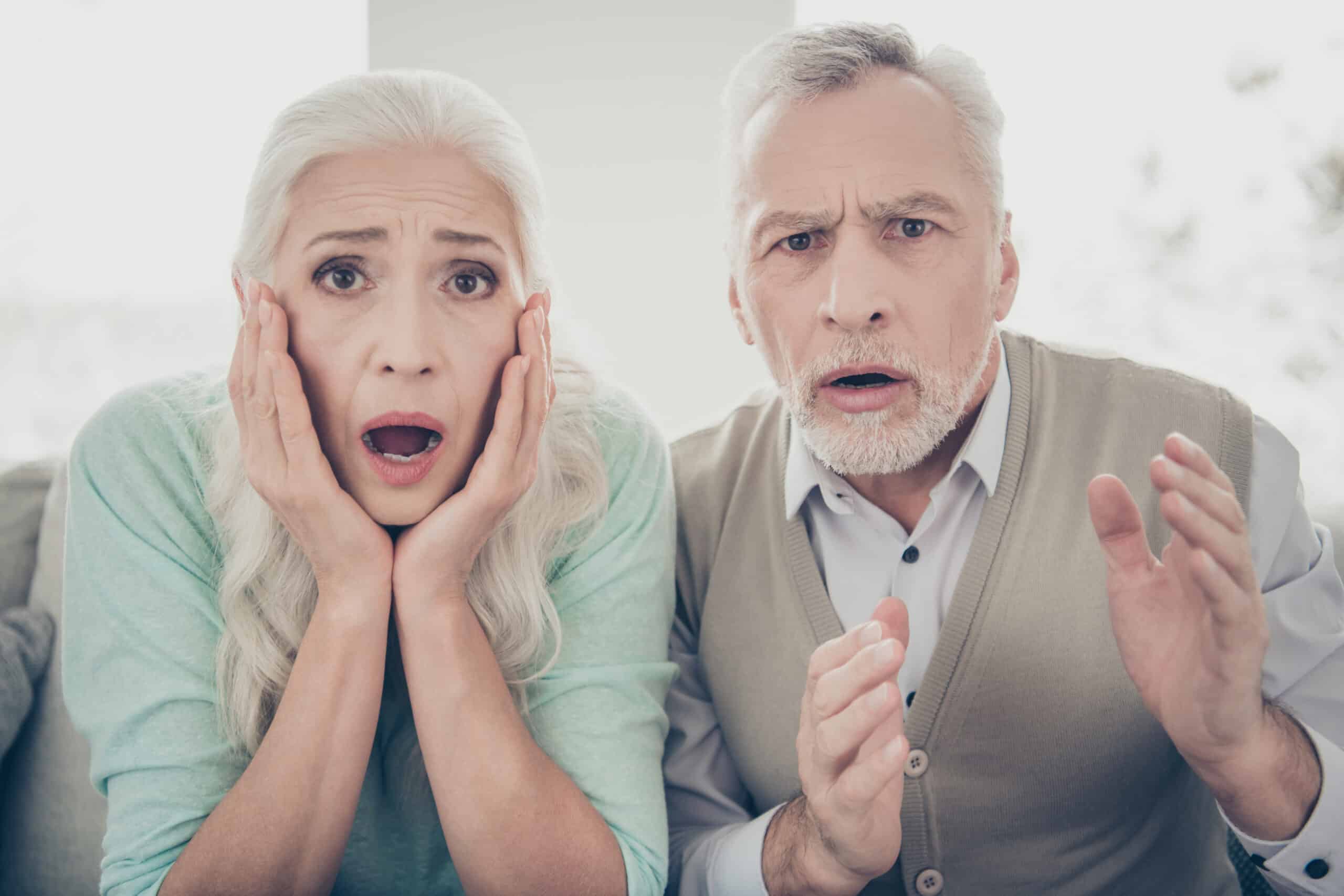 older man and woman couple scared