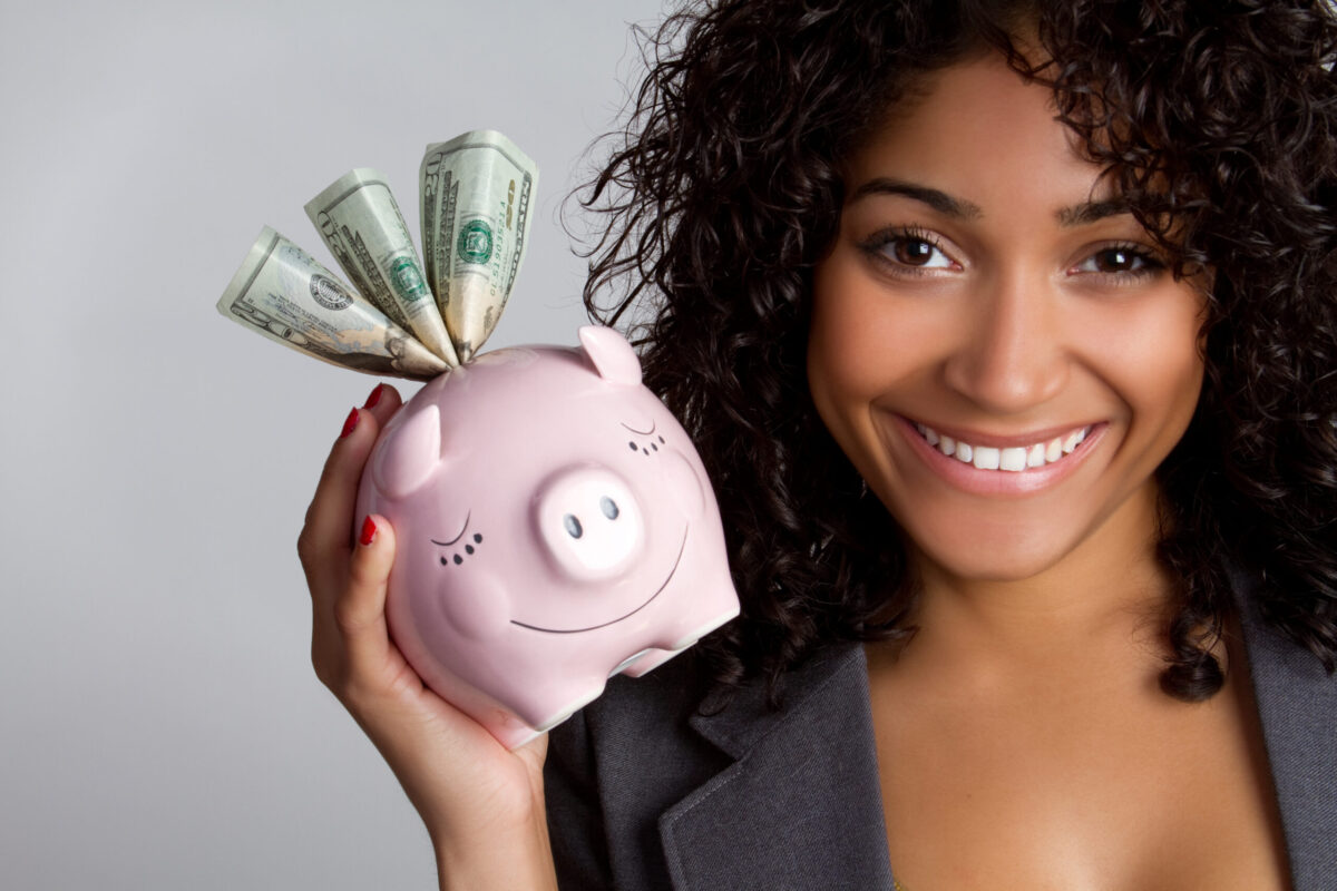 woman holding piggy bank with money