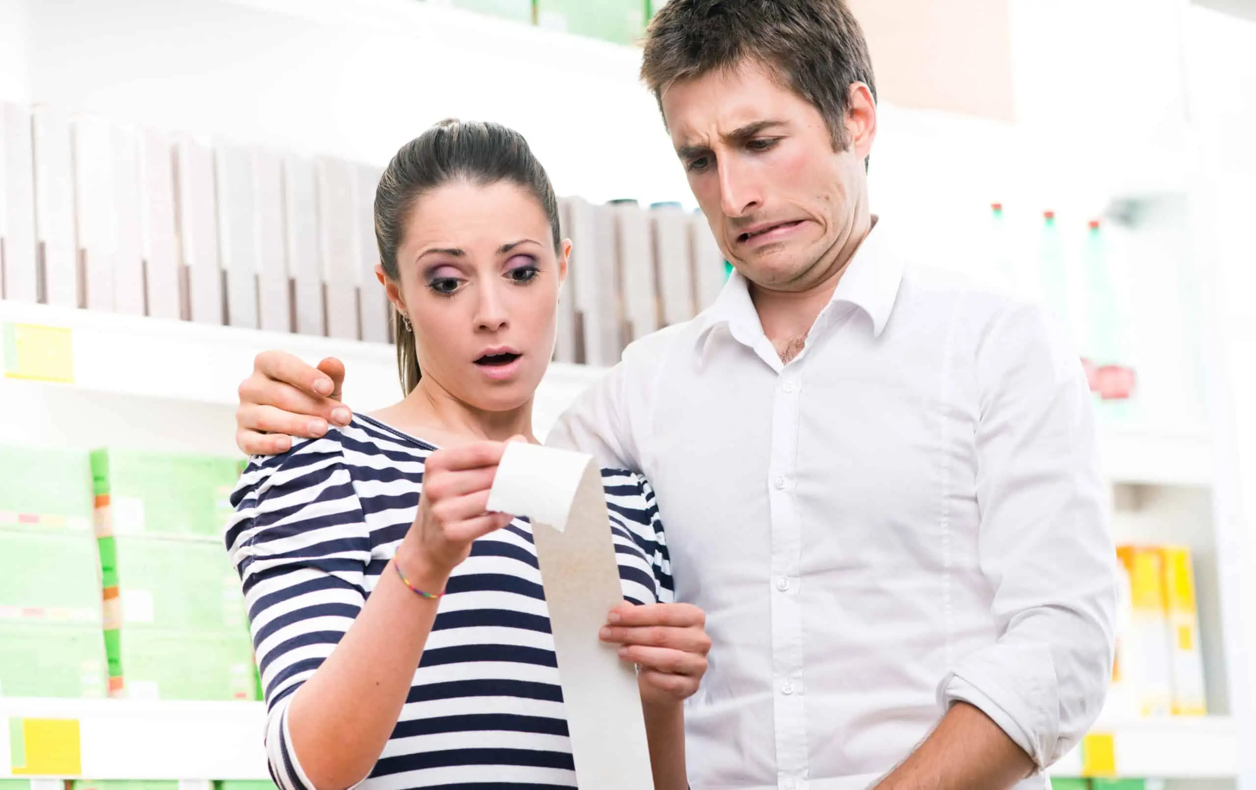 surprised couple reading receipt