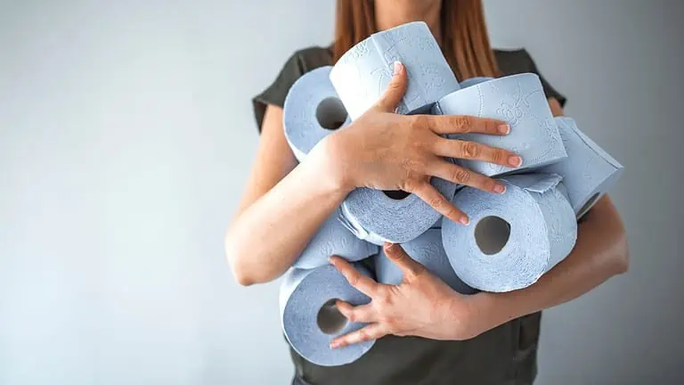 woman holding toilet paper ss - 12 Simple Ways to Save Money That Don't Require Extreme Frugality