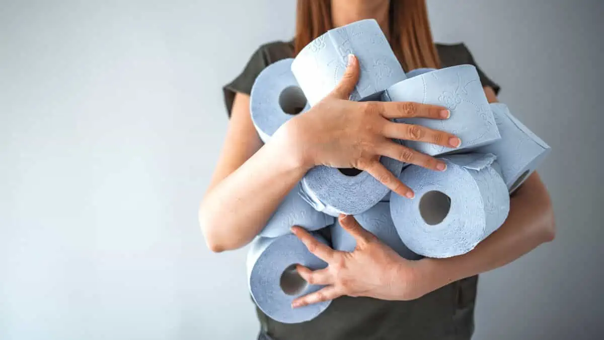 woman holding toilet paper ss - Buyer Beware: 13 Things You Should Never Buy at Walmart