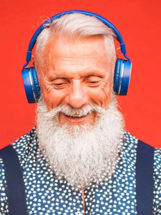 Trendy,Senior,Man,Using,Smartphone,App,With,Red,Backgorund,-