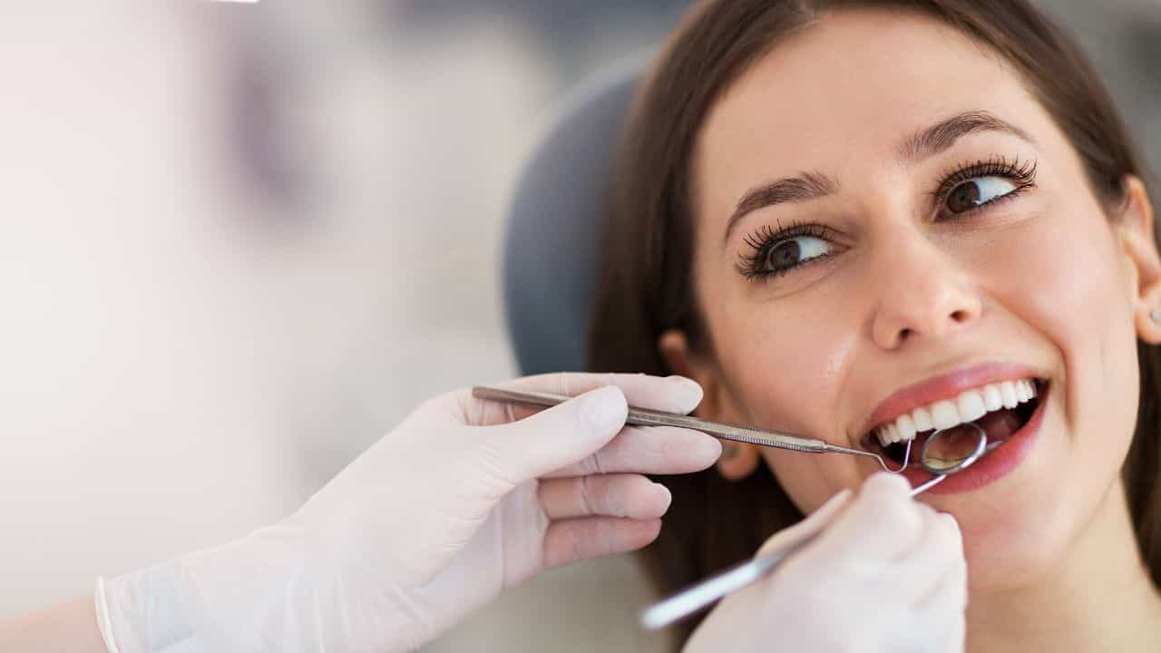 woman at dentist ss - 12 Greatest Scams In Human History: Including One You're Probably Drinking Right Now