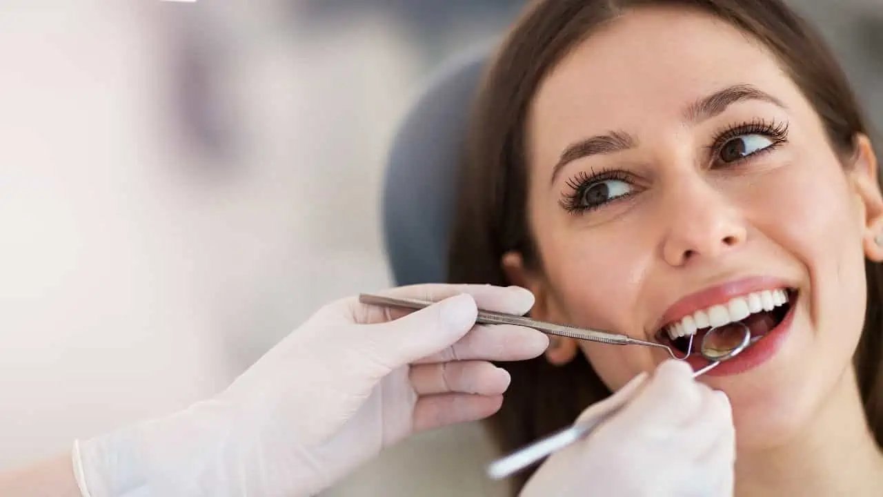 woman at dentist ss - 12 Boldest Scams In Modern History - That People Got Away With