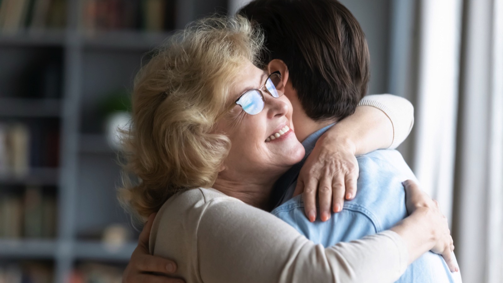 Elderly mother hugging son