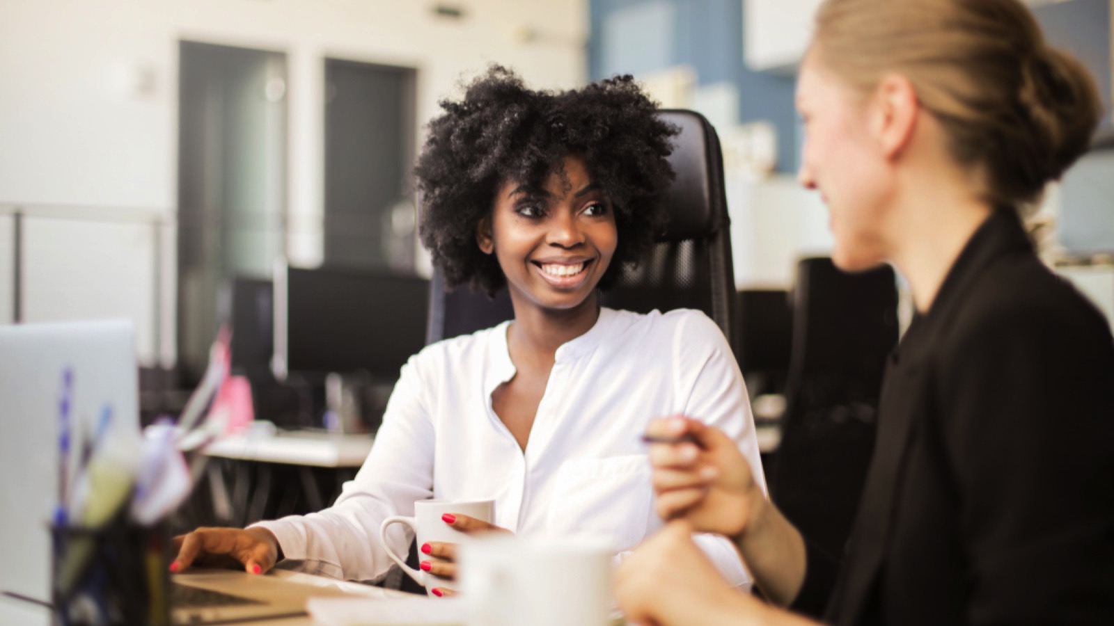 18 Mistakes New Employees Make Their First Week on the Job - Don't Be One of Them 3 Woman discussing with co worker