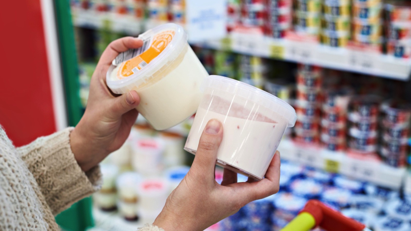 Grocery Budget Busters: 15 Essentials That Have Gotten Too Expensive for Average Americans 13 Buying Yogurt in supermarket