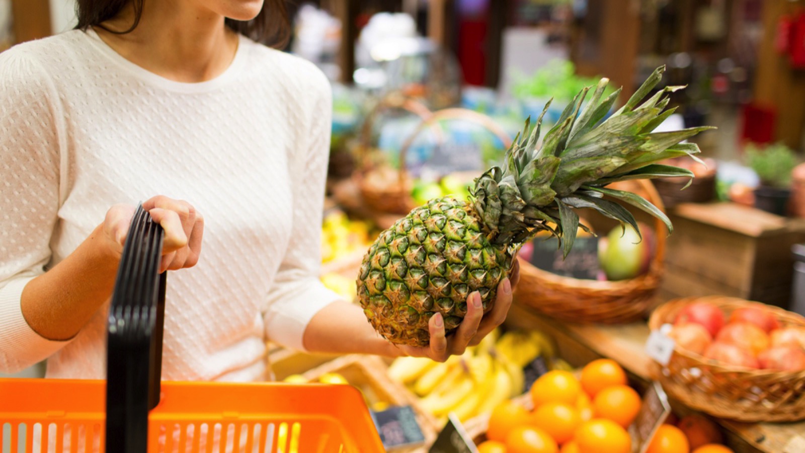 Grocery Budget Busters: 15 Essentials That Have Gotten Too Expensive for Average Americans 11 Buying pineapple