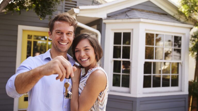 Couples with keys buying house
