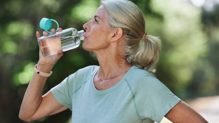 Old woman drinking water