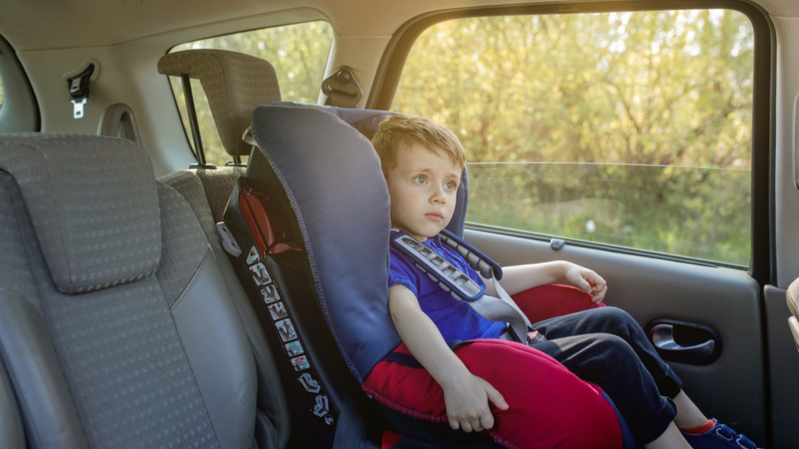 Kid siting alone in car
