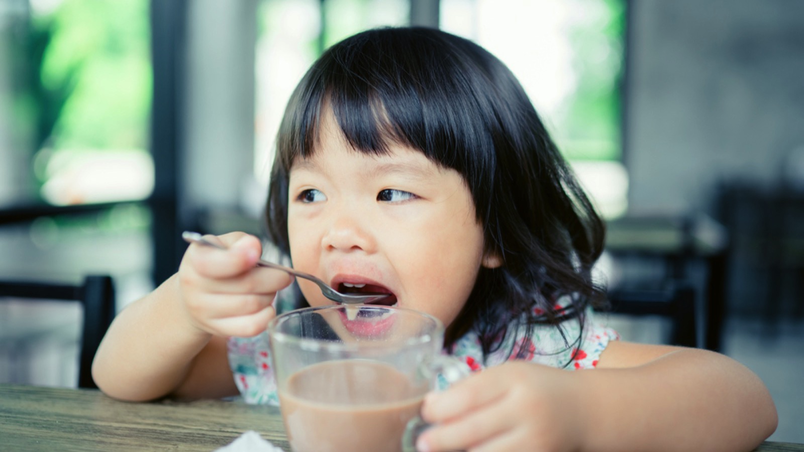 Little girl drinking chocolate milk