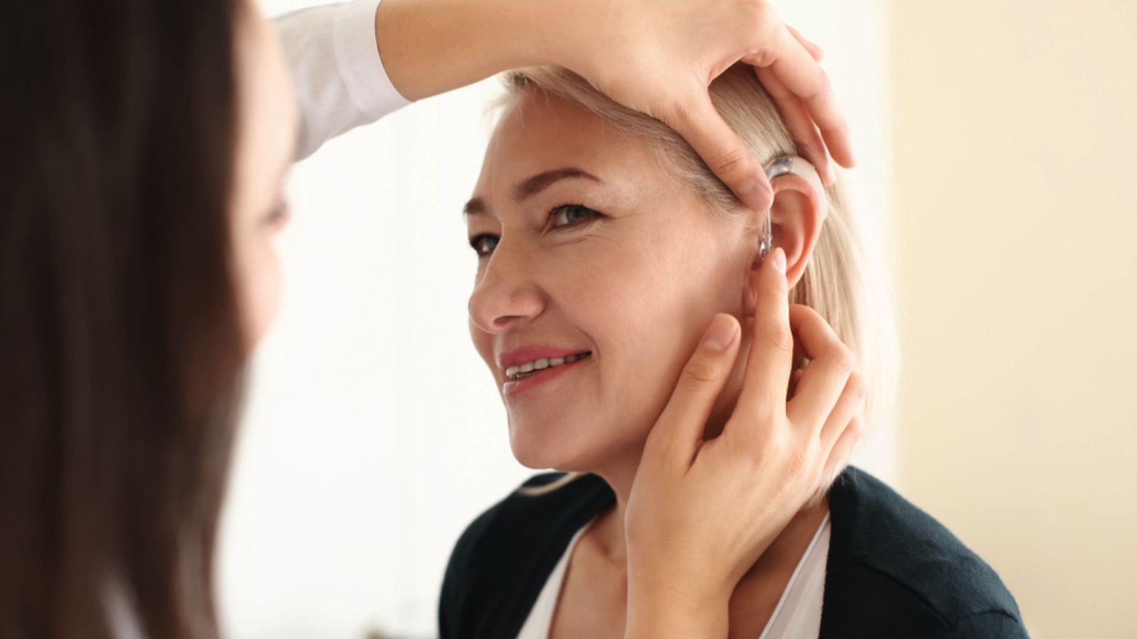 Woman getting fixed with Hearing Aids