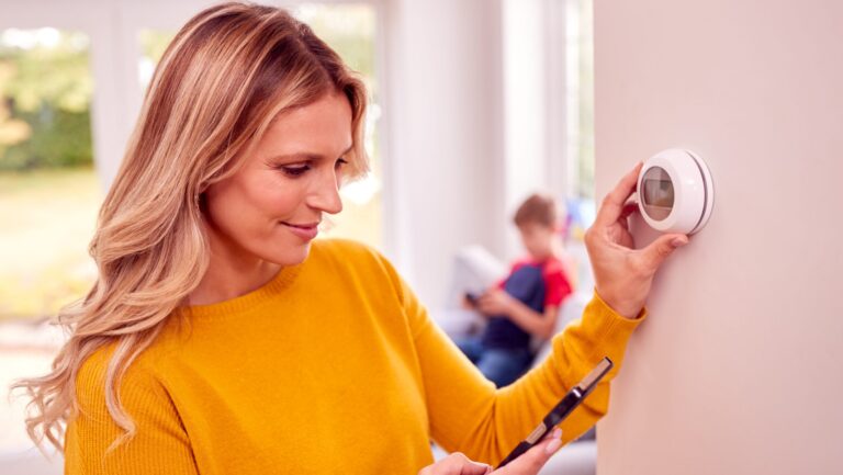 woman setting thermostat